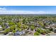 Wide aerial shot capturing a vibrant neighborhood, with lush trees dotting the landscape and a clear blue sky above at 13323 Birch Cir, Thornton, CO 80241
