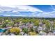 Panoramic aerial view showcasing a sprawling neighborhood, mature trees, and a picturesque skyline at 13323 Birch Cir, Thornton, CO 80241