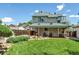 Large backyard with a covered patio, mature trees, and a well-maintained lawn, ideal for outdoor activities at 13323 Birch Cir, Thornton, CO 80241