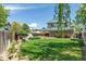 Spacious backyard with lush green lawn, a wooden fence, and a covered patio, perfect for relaxing at 13323 Birch Cir, Thornton, CO 80241