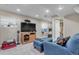 Basement entertainment area with a large television, comfortable seating, and recessed lighting at 13323 Birch Cir, Thornton, CO 80241