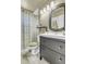 Well-maintained bathroom features wood-style vanity, patterned shower curtain, and updated fixtures at 13323 Birch Cir, Thornton, CO 80241