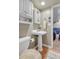 Basement bathroom featuring a pedestal sink, updated fixtures, and a tile floor at 13323 Birch Cir, Thornton, CO 80241