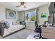 Cozy bedroom featuring a comfortable daybed, soft carpet, large window and neutral paint at 13323 Birch Cir, Thornton, CO 80241