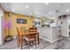 Cozy dining area with wood floors and ample lighting, perfect for Gathering meals and entertaining guests at 13323 Birch Cir, Thornton, CO 80241