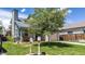 Charming single-Gathering home boasts a well-manicured lawn, mature trees, and a welcoming front porch at 13323 Birch Cir, Thornton, CO 80241