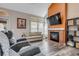 Warm and inviting living room with a brick fireplace and large windows, creating a comfortable atmosphere at 13323 Birch Cir, Thornton, CO 80241