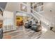 Bright and airy living room featuring an open layout, staircase, and modern flooring, perfect for entertaining at 13323 Birch Cir, Thornton, CO 80241