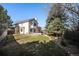 Expansive backyard featuring a well-maintained lawn and mature trees creating a serene outdoor space at 8825 Fairview Oaks Pl, Lone Tree, CO 80124