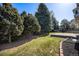 Home boasting a spacious backyard with lush green grass and mature trees, perfect for outdoor enjoyment at 8825 Fairview Oaks Pl, Lone Tree, CO 80124