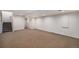 Large basement with neutral carpet, ample space for entertaining, and a staircase leading upstairs at 8825 Fairview Oaks Pl, Lone Tree, CO 80124