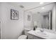 Clean half bath features a single vanity, framed mirror, and toilet at 8825 Fairview Oaks Pl, Lone Tree, CO 80124