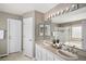 Large primary bath with double sinks, a soaking tub, and a glass enclosed shower at 8825 Fairview Oaks Pl, Lone Tree, CO 80124