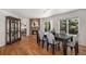 Inviting dining room with hardwood floors, a fireplace, and sliding glass doors to the backyard at 8825 Fairview Oaks Pl, Lone Tree, CO 80124