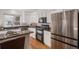 Modern kitchen featuring stainless steel appliances, granite countertops, and hardwood floors at 8825 Fairview Oaks Pl, Lone Tree, CO 80124