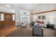 The bright living room is a comfortable space featuring a large window and vaulted ceiling at 8825 Fairview Oaks Pl, Lone Tree, CO 80124