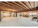 Unfinished basement featuring exposed wooden beams, concrete flooring, and open layout offering customization possibilities at 1896 Hogan Ct, Castle Rock, CO 80109