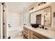 Bathroom with double vanity, black hardware, and tub/shower combo at 1896 Hogan Ct, Castle Rock, CO 80109