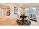 Cozy dining area featuring modern lighting, a hardwood floor and a convenient kitchen pass-through at 1896 Hogan Ct, Castle Rock, CO 80109