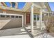 Charming home exterior featuring a covered front porch, attached garage, and neutral color scheme at 1896 Hogan Ct, Castle Rock, CO 80109