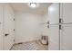 Bright laundry room featuring white cabinets, wire shelving, neutral paint, and vinyl flooring for a clean and functional space at 1896 Hogan Ct, Castle Rock, CO 80109