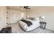 Inviting main bedroom featuring neutral tones, a modern ceiling fan, and a glimpse into the ensuite at 1896 Hogan Ct, Castle Rock, CO 80109