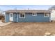 Backyard featuring a simple layout, showcasing the blue exterior of the home and a practical backdoor entrance at 4211 E 69Th Ave, Commerce City, CO 80022