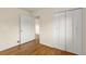 Bedroom with hardwood flooring, closet and an open doorway at 4211 E 69Th Ave, Commerce City, CO 80022
