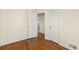 Bedroom with hardwood floors, white walls, and white doors at 4211 E 69Th Ave, Commerce City, CO 80022