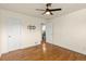 This is a bedroom with hardwood floors, ceiling fan, and doors to closet and bathroom at 4211 E 69Th Ave, Commerce City, CO 80022