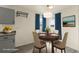 Bright dining area features a wood table and neutral tone dining chairs with window views at 4211 E 69Th Ave, Commerce City, CO 80022