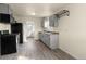 Updated kitchen with stainless steel appliances, grey cabinetry, and modern countertops at 4211 E 69Th Ave, Commerce City, CO 80022