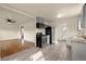 Open-concept kitchen with stainless steel appliances, flowing into living area with hardwood floors at 4211 E 69Th Ave, Commerce City, CO 80022