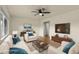Bright living room featuring stylish furnishings, a ceiling fan, and hardwood floors at 4211 E 69Th Ave, Commerce City, CO 80022