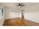 Spacious living room with gleaming hardwood floors and a modern ceiling fan at 4211 E 69Th Ave, Commerce City, CO 80022