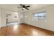 Inviting living room showcasing hardwood floors, natural light, and a seamless flow to the kitchen at 4211 E 69Th Ave, Commerce City, CO 80022