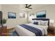 Staged main bedroom featuring a large bed, stylish decor, and natural lighting at 4211 E 69Th Ave, Commerce City, CO 80022