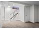 Basement featuring neutral carpet, stairs with railing, white walls and a door at 1211 E 26Th Ave, Denver, CO 80205
