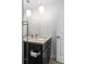 Elegant bathroom featuring a stylish vanity with storage, decorative lighting, and a modern sink at 1211 E 26Th Ave, Denver, CO 80205