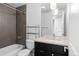 Modern bathroom featuring gray tiling, a sleek vanity with drawers, and a shower-tub combination at 1211 E 26Th Ave, Denver, CO 80205