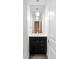 Modern half bath featuring pendant lighting, a decorative mirror and sleek fixtures at 1211 E 26Th Ave, Denver, CO 80205