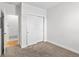 Bedroom featuring neutral carpet, white walls and a closet with sliding doors for optimal storage at 1211 E 26Th Ave, Denver, CO 80205