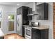 Modern kitchen featuring stainless steel appliances and dark cabinetry at 1211 E 26Th Ave, Denver, CO 80205