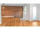 Open concept living area with exposed brick wall and hardwood floors at 1211 E 26Th Ave, Denver, CO 80205