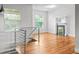 Bright living room with hardwood floors and open staircase, offering a view of the decorative fireplace at 1211 E 26Th Ave, Denver, CO 80205