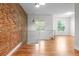 Open concept living area with exposed brick wall and hardwood floors at 1211 E 26Th Ave, Denver, CO 80205