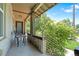 Charming covered porch with stylish railings and seating, overlooking the lush front yard at 1211 E 26Th Ave, Denver, CO 80205