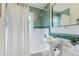 Bathroom featuring green and white tiled walls, a sink, and a bathtub at 1557 North St, Boulder, CO 80304