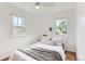 Bright bedroom with hardwood floors, windows, and a ceiling fan at 1557 North St, Boulder, CO 80304