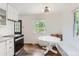 Eat-in kitchen with lots of natural light, white cabinets, and a dark oven at 1557 North St, Boulder, CO 80304